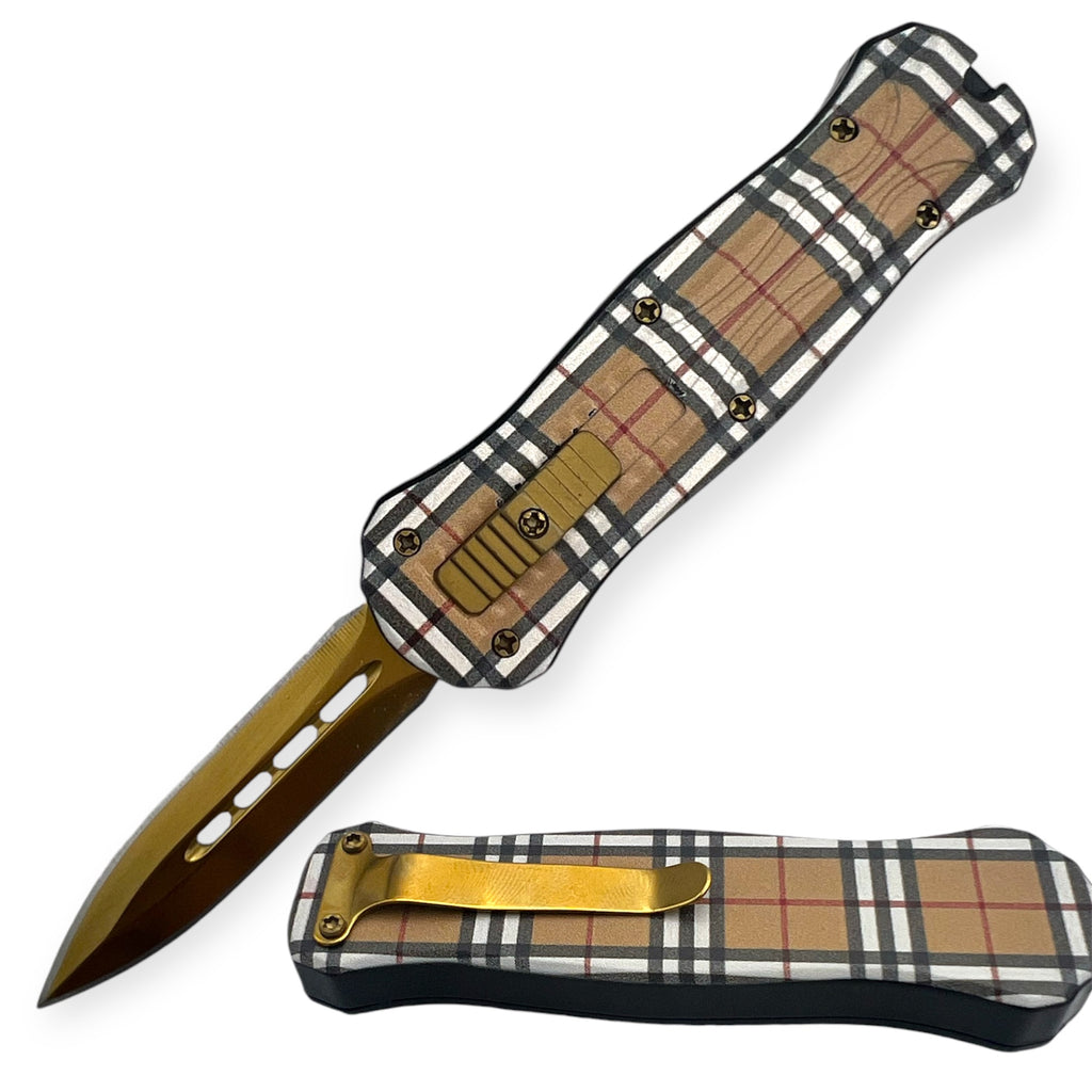 Miniature OTF automatic knife with a black, gold, and tan plaid handle, gold accents, and a partially serrated blade.