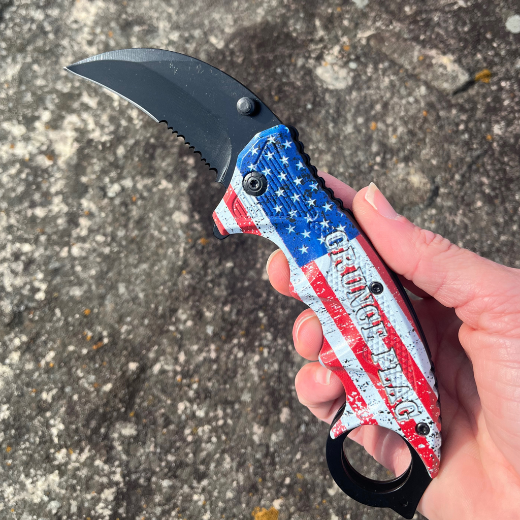 Measuring 7.5 inches in length, this Grunge Flag Karambit folding knife features a 1065 German surgical steel blade, making it an official Tiger-USA® knife. A weighing 4.27 ounces, this knife is heavy duty and spring assisted, yet remains affordable.