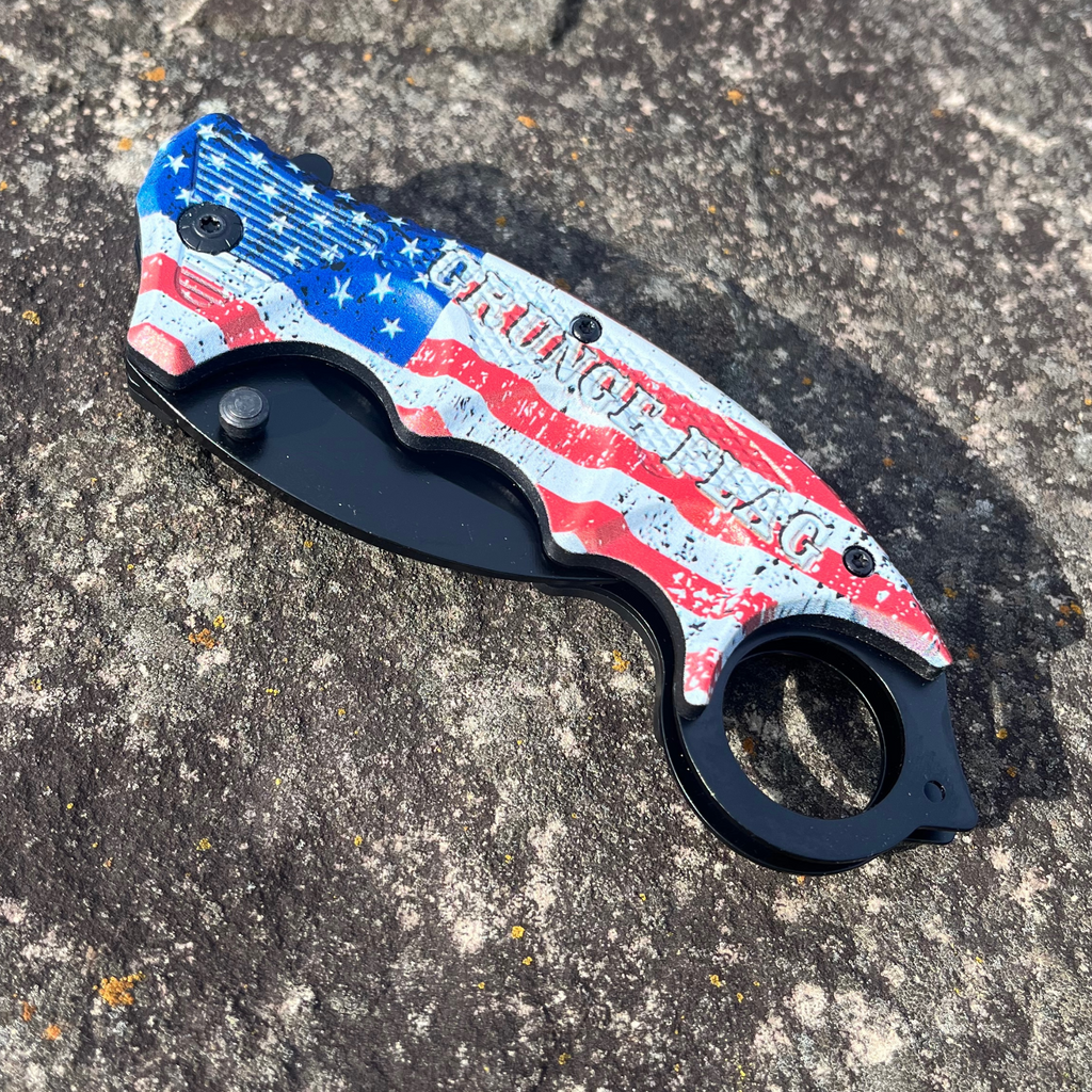 Measuring 7.5 inches in length, this Grunge Flag Karambit folding knife features a 1065 German surgical steel blade, making it an official Tiger-USA® knife. A weighing 4.27 ounces, this knife is heavy duty and spring assisted, yet remains affordable.